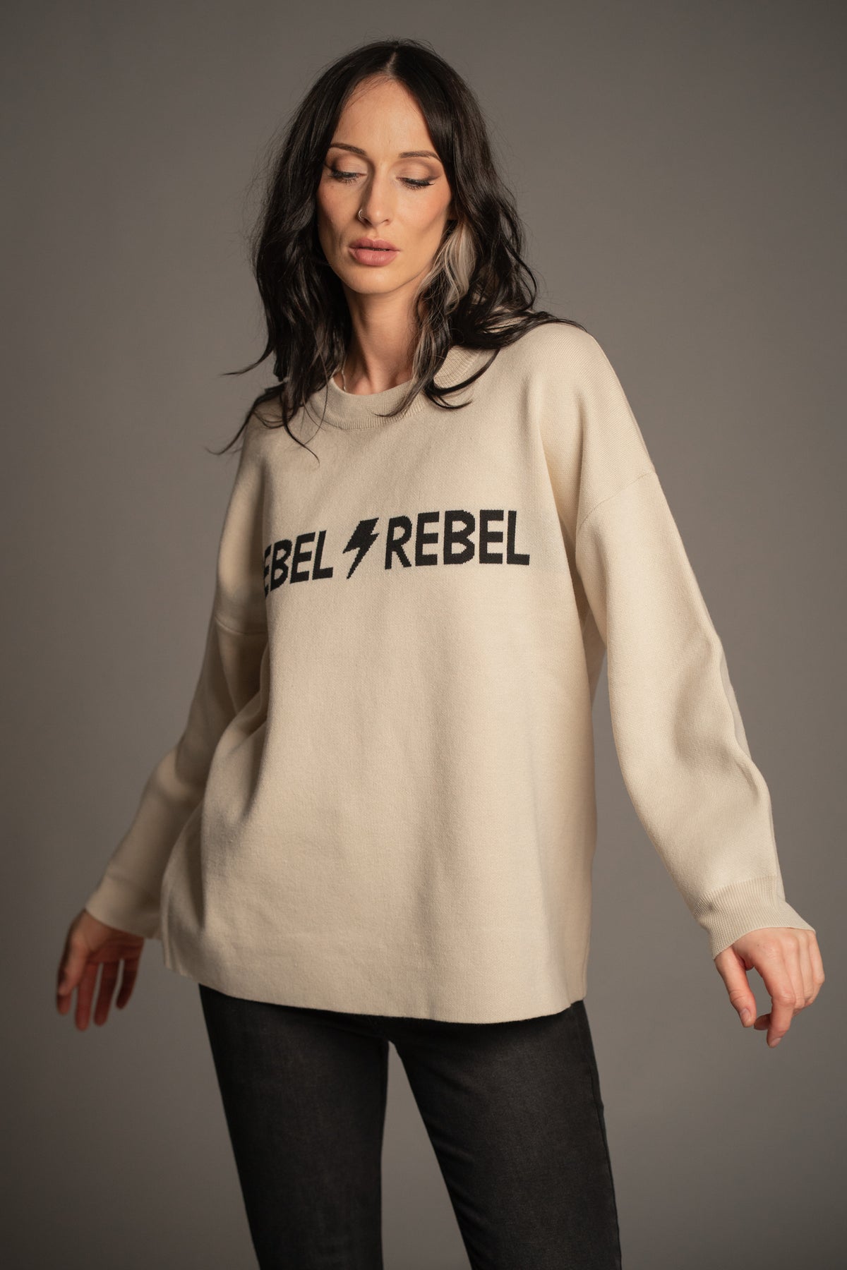 Victoria wearing the Rebel Rebel Cream Knit Jumper with Hendrix Denim Flares — front view