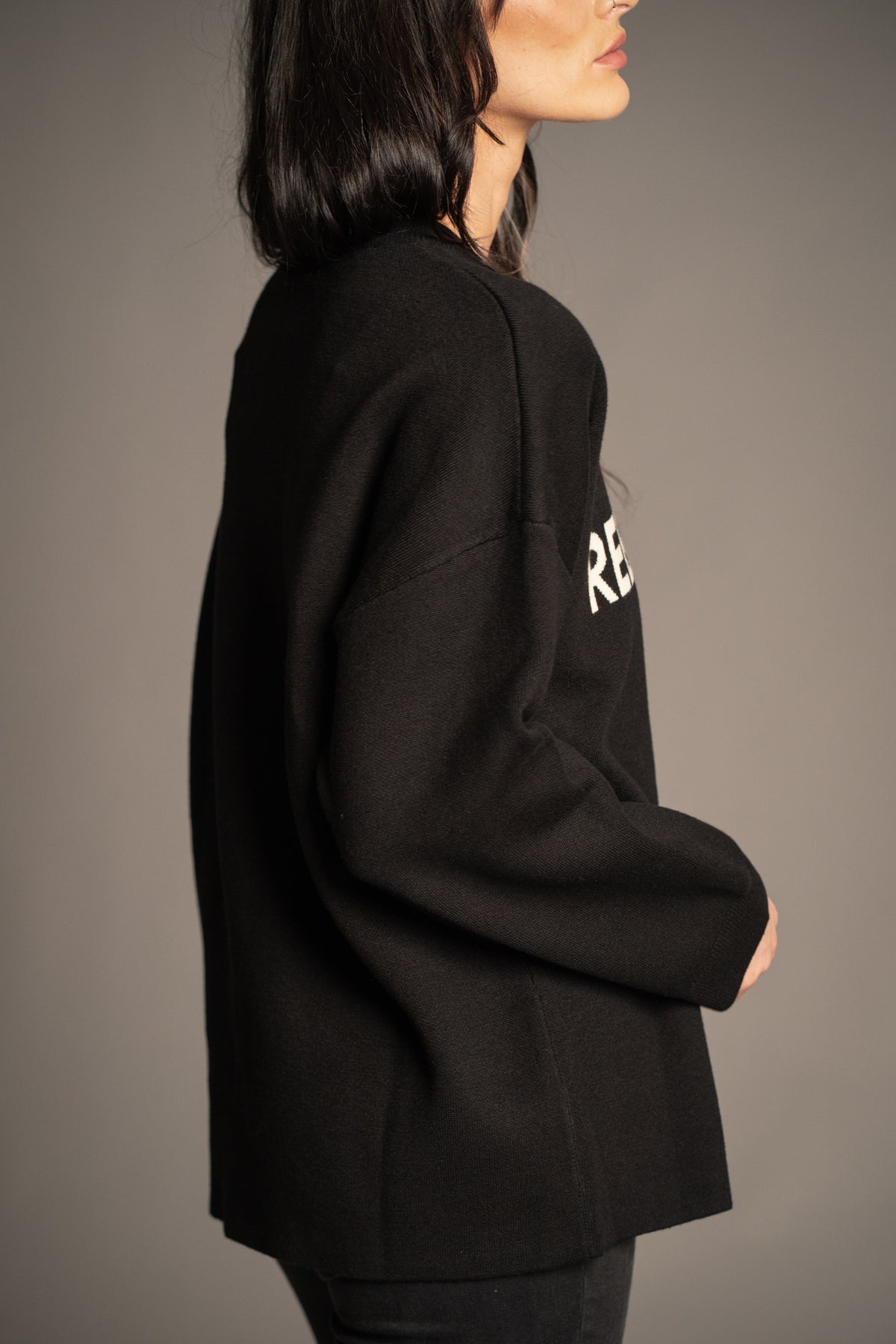 Rebel Rebel Black Graphic Knit Jumper side view showing long sleeves and easy oversized silhouette