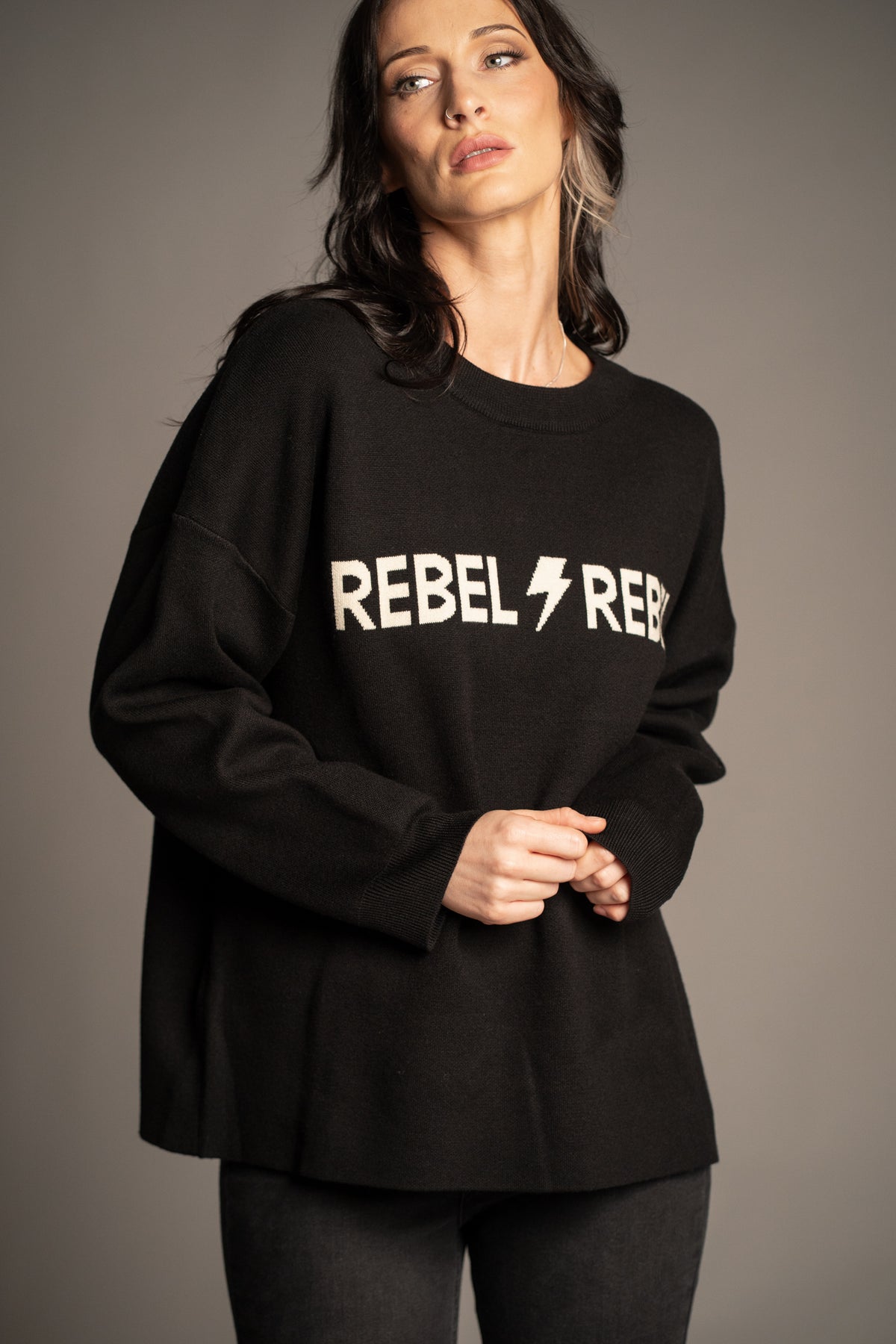Rebel Rebel Graphic Knit Jumper in black with ivory Rebel Rebel slogan and lightning bolt — front view