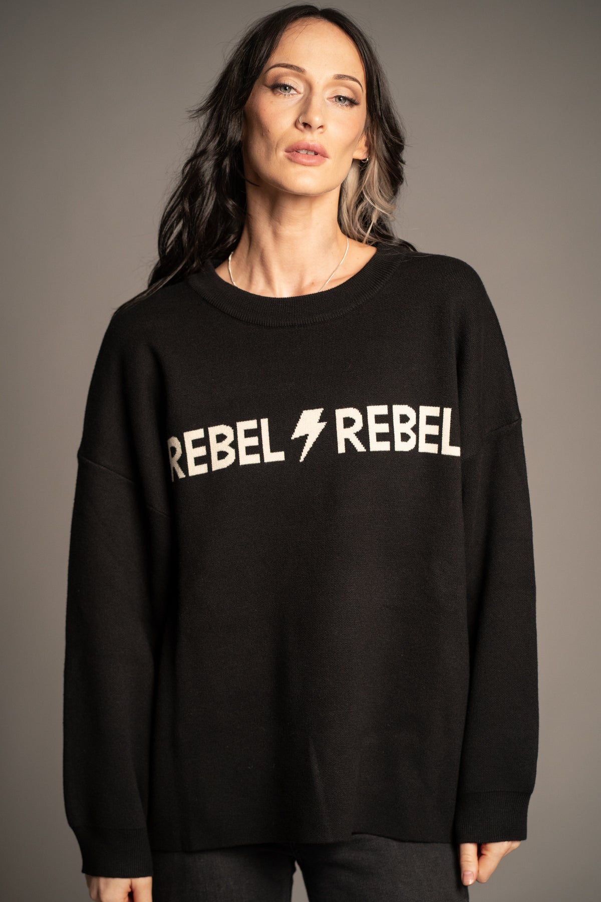 Close-up of Rebel Rebel Knit Jumper showing Rebel Rebel graphic and lightning bolt design
