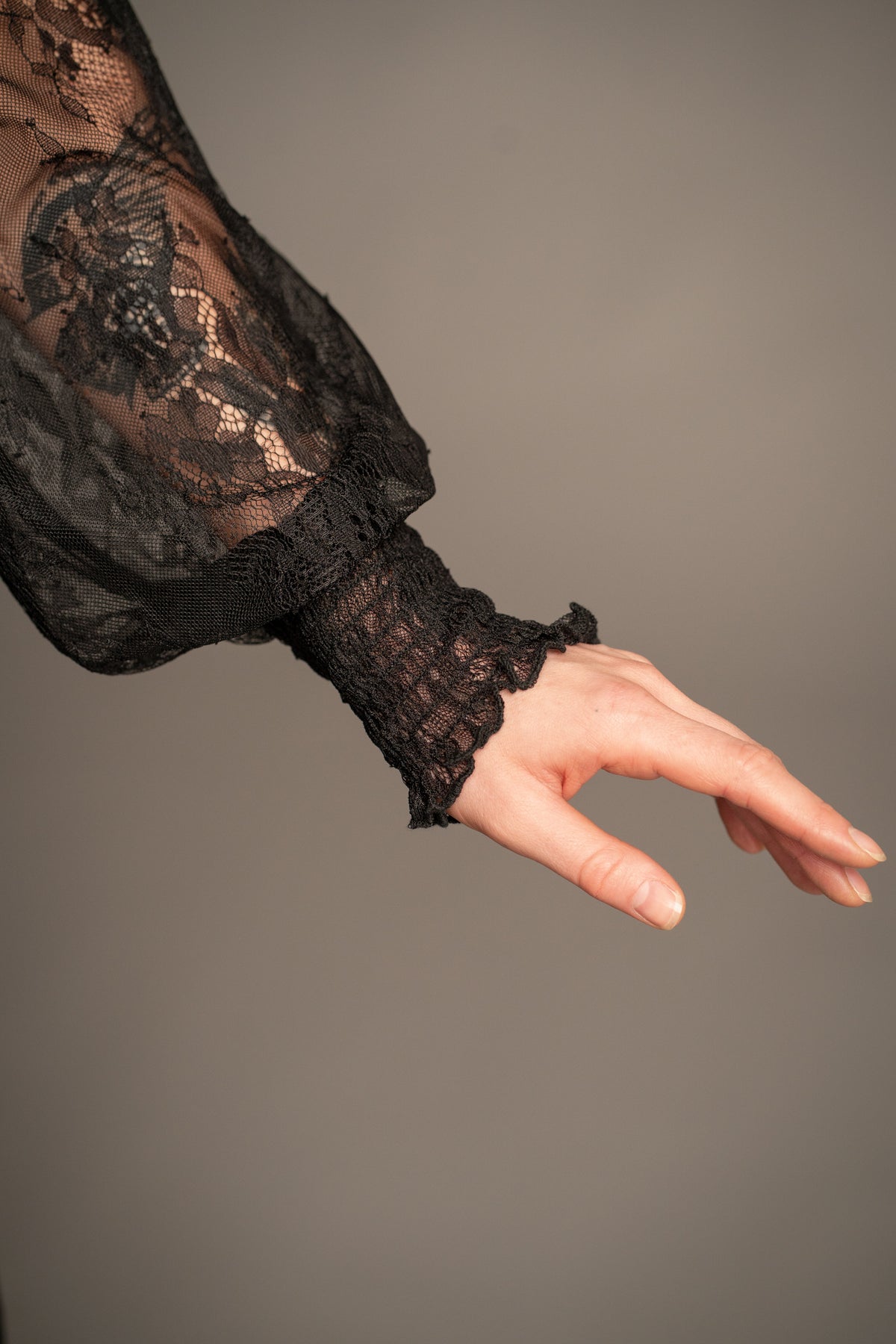 Close-up of Rhiannon black lace maxi dress featuring sheer balloon sleeve and lace cuff detail