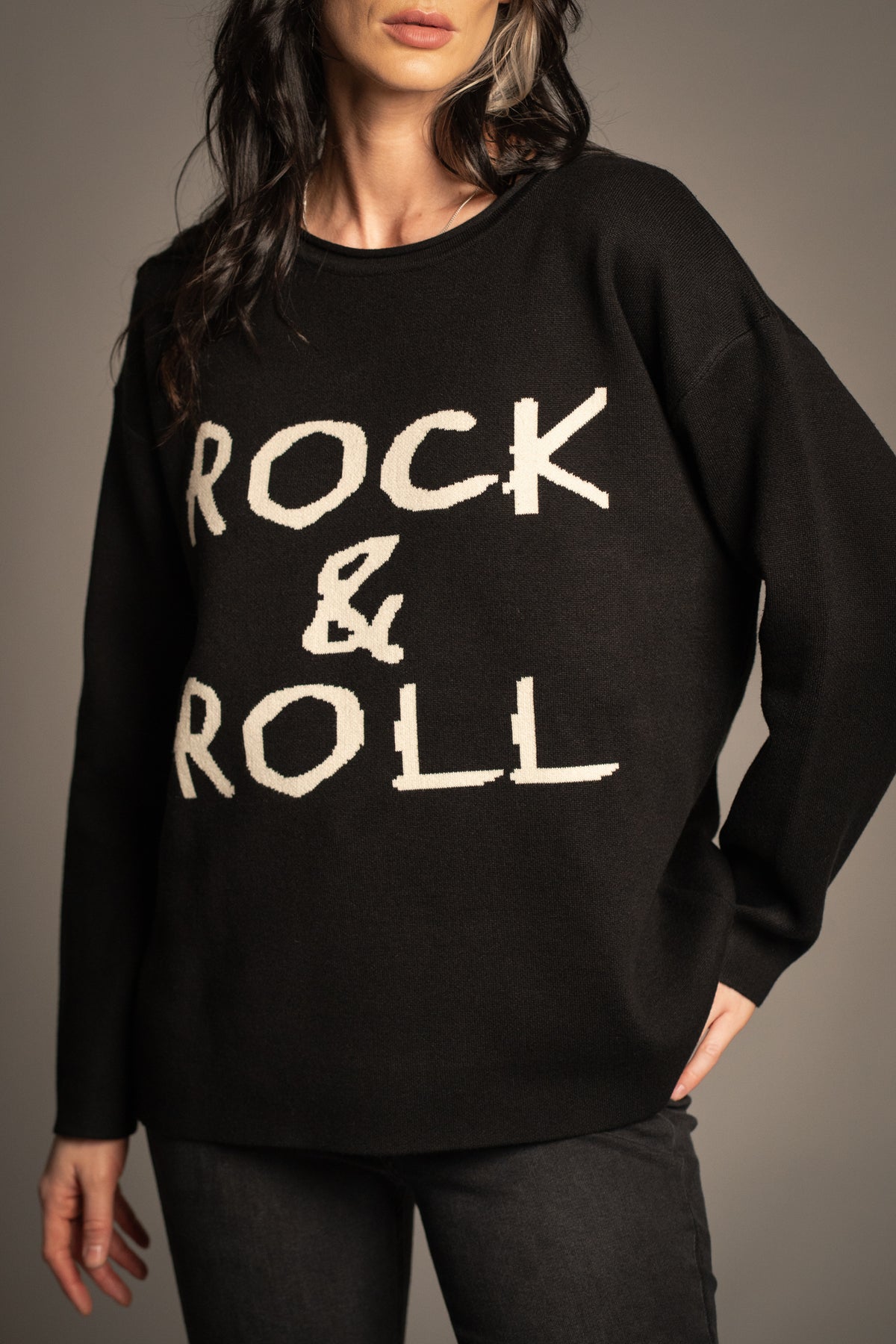 Close-up of the Little Lies Rock & Roll Knit Jumper featuring oversized ivory slogan lettering on soft black knit fabric
