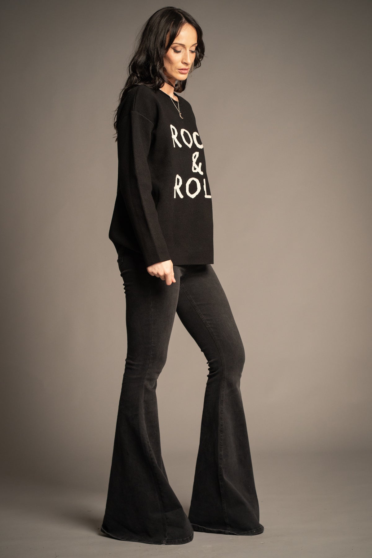 Little Lies Rock & Roll Knit Jumper side profile showing an easy oversized fit and fine knit texture, styled with Hendrix Denim flares