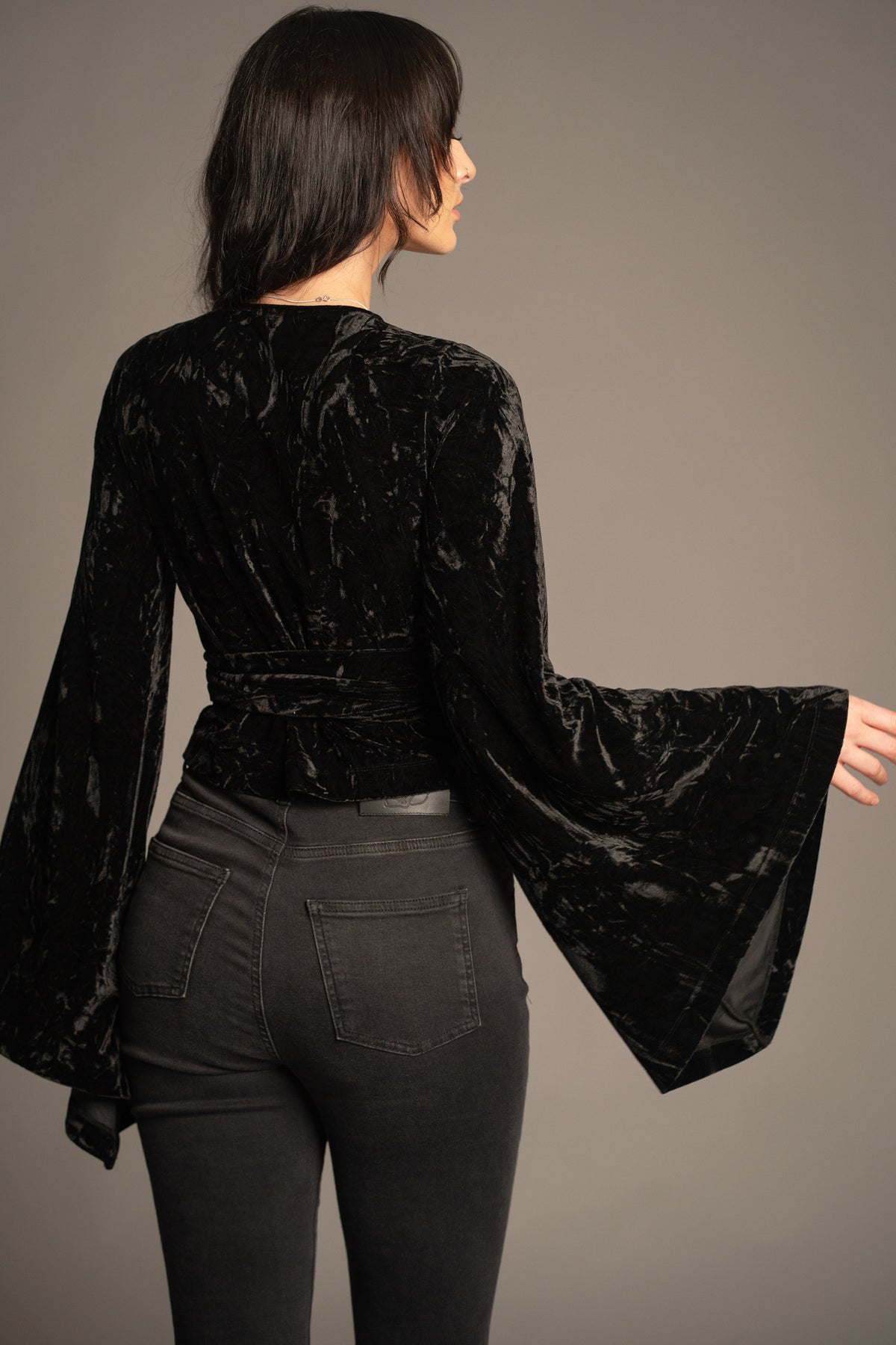 Sally black velvet wrap top back view featuring crushed velvet fabric, wrap silhouette and flared sleeves