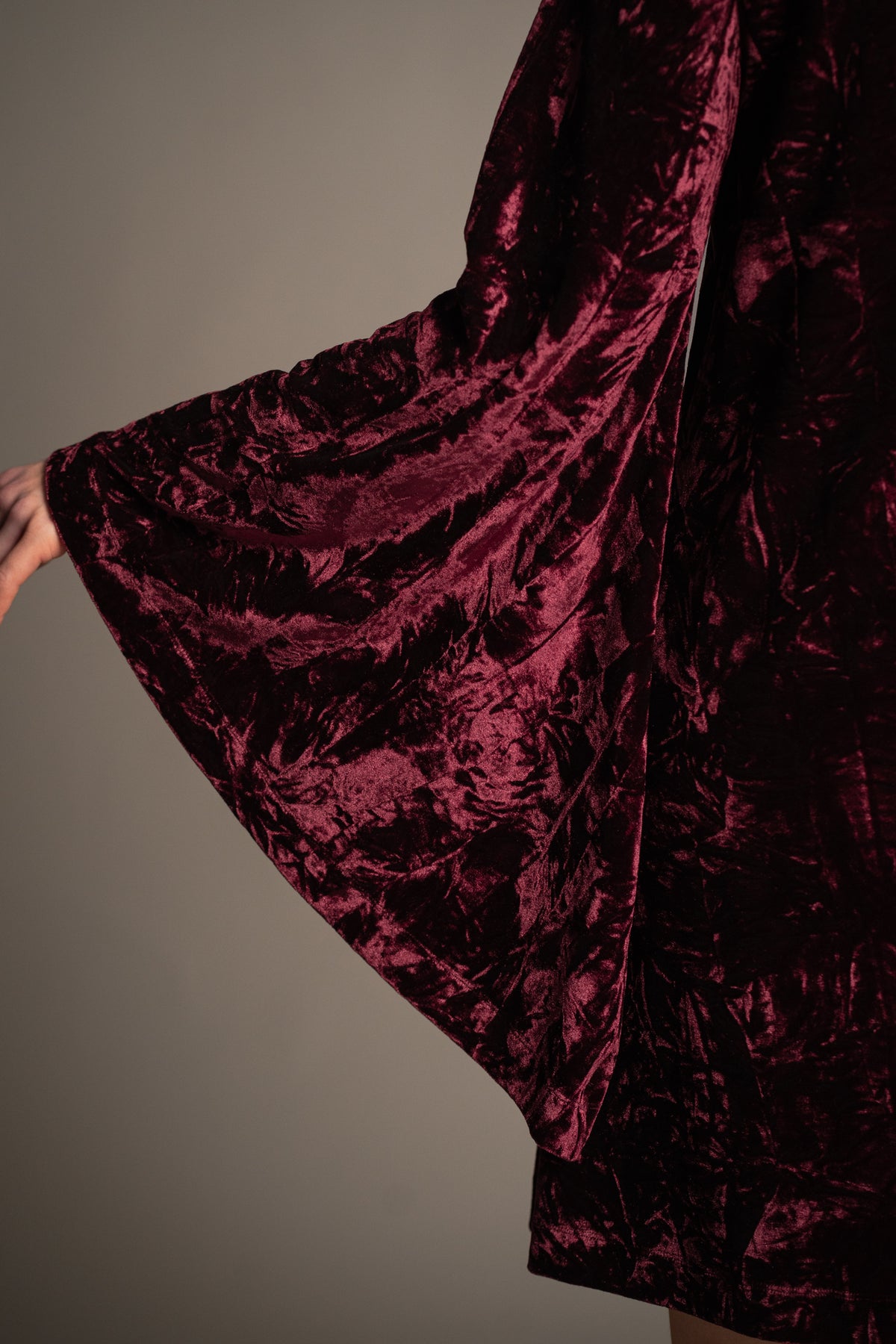 Sara merlot velvet mini dress back view featuring relaxed swing silhouette, long bell sleeves and crushed velvet finish