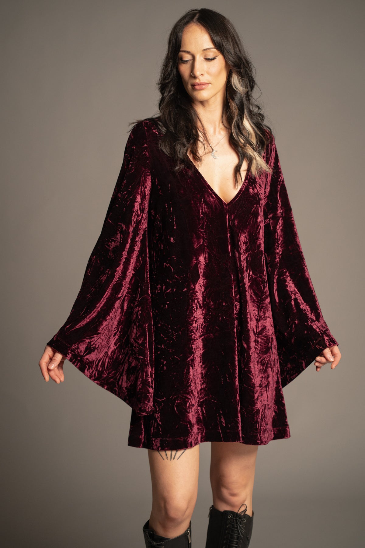 Sara merlot velvet mini dress with deep V-neckline, crushed velvet fabric and flowing bell sleeves front view