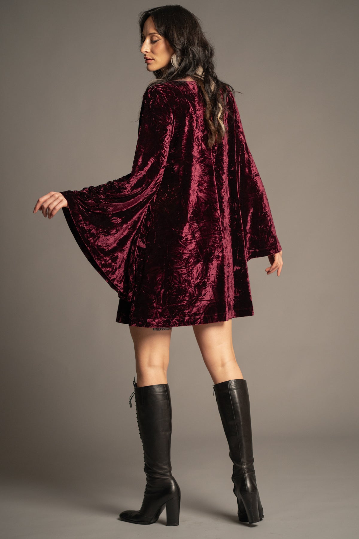 Sara merlot velvet mini dress back view featuring relaxed swing silhouette, long bell sleeves and crushed velvet finish