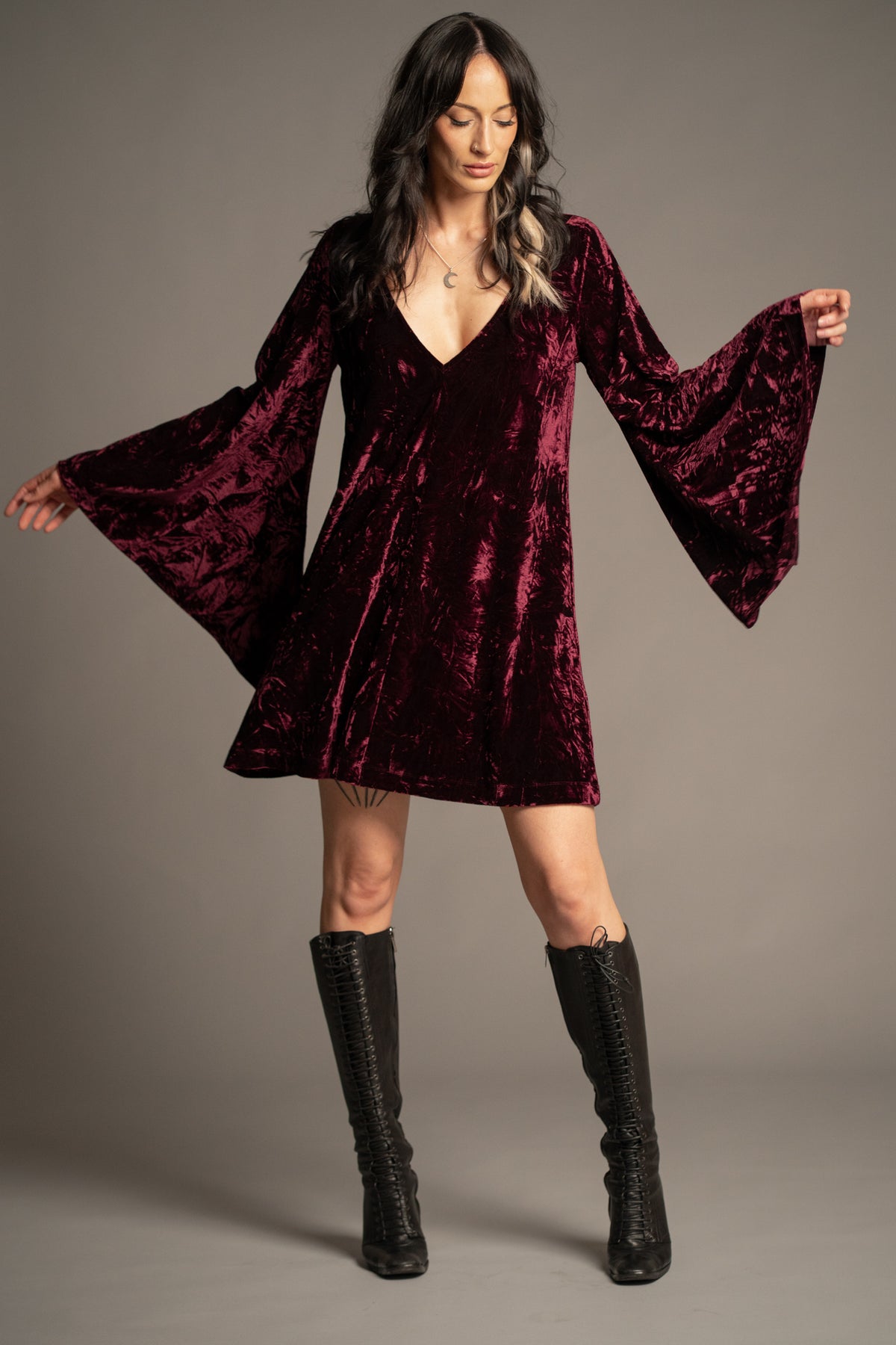 Sara merlot velvet mini dress with deep V-neckline, crushed velvet fabric and flowing bell sleeves front view
