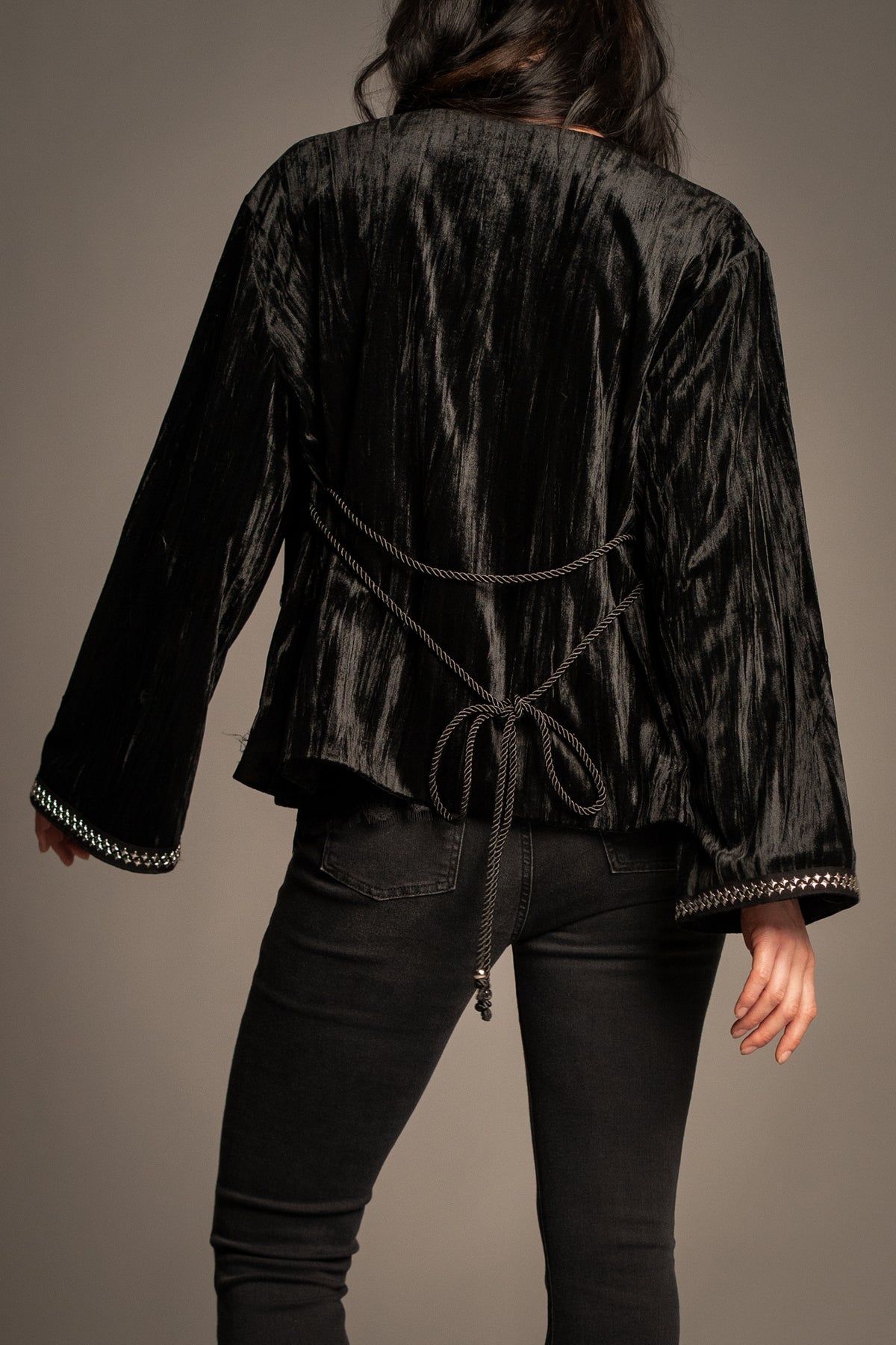 Close-up of Silver Springs studded velvet jacket showcasing silver stud trim, tie-back detail and luxurious crushed velvet texture