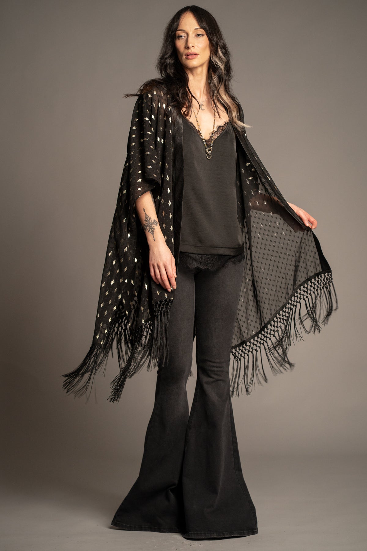 Songbird black metallic kimono with gold foil star print, tassel fringe hem and flowing open-front silhouette front view