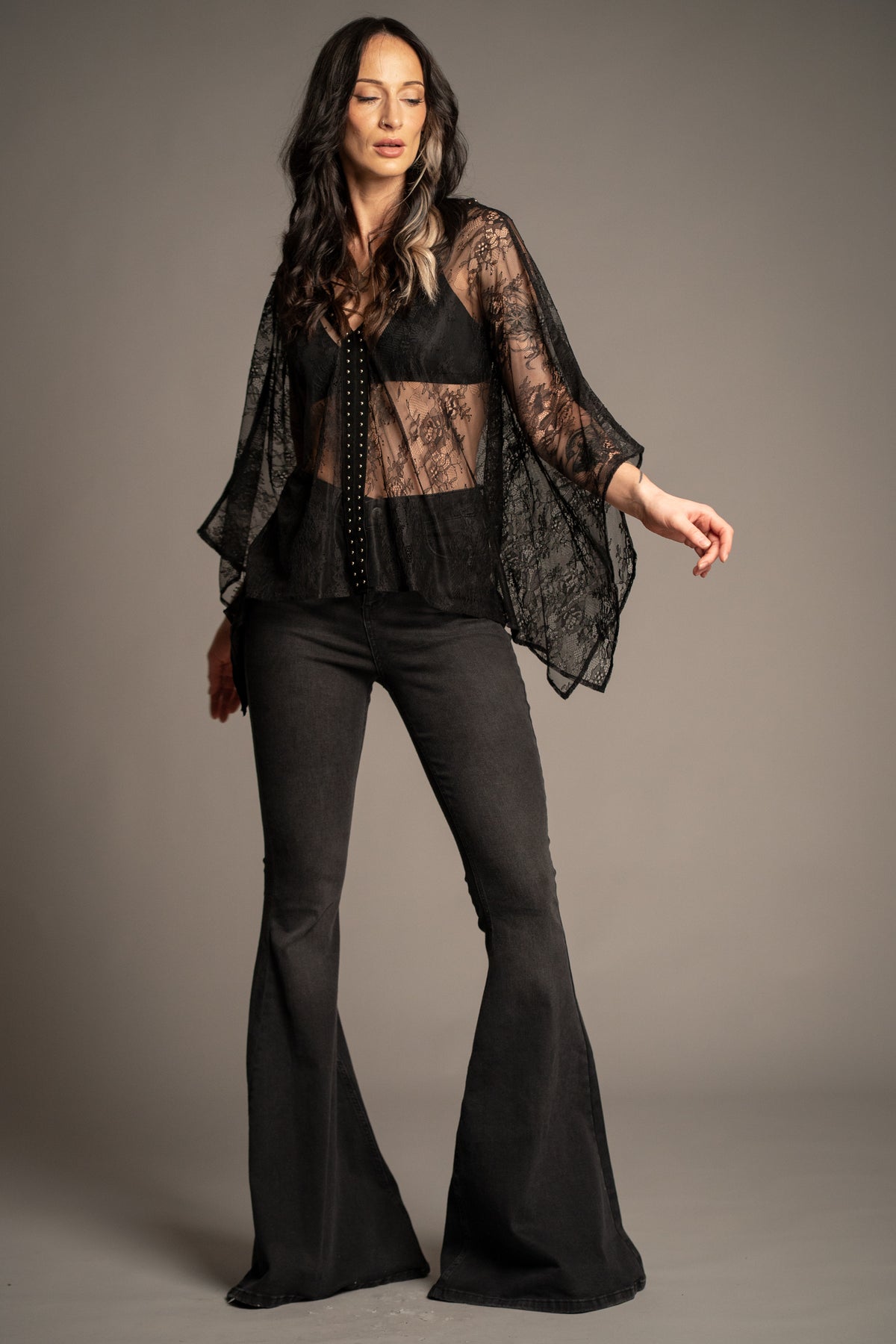 Spellbound studded lace kimono top featuring sheer black floral lace, studded trim and flowing kimono sleeves front view