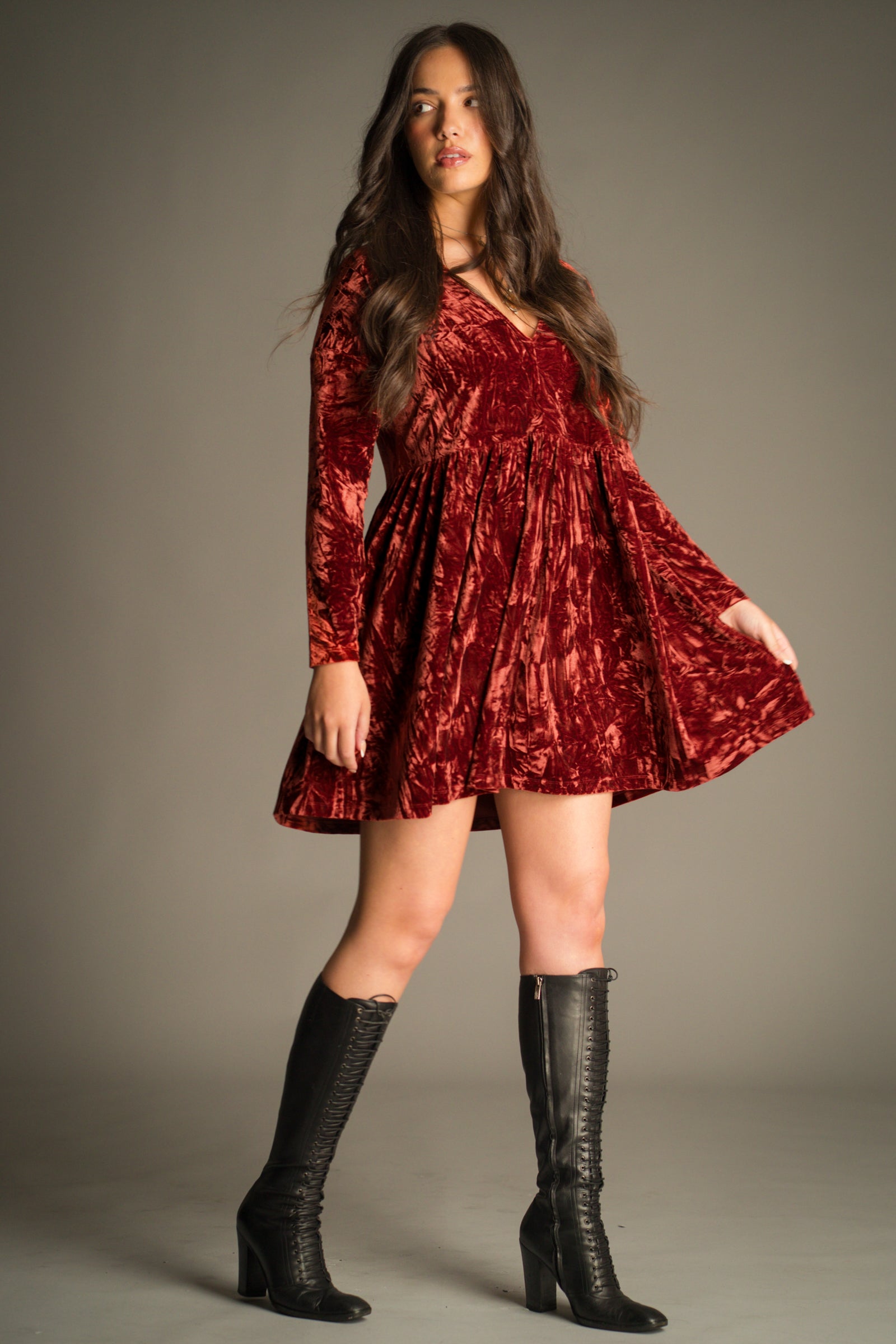 Full length view of the Velvet Goldmine Rust Smock Dress showing hem detail.