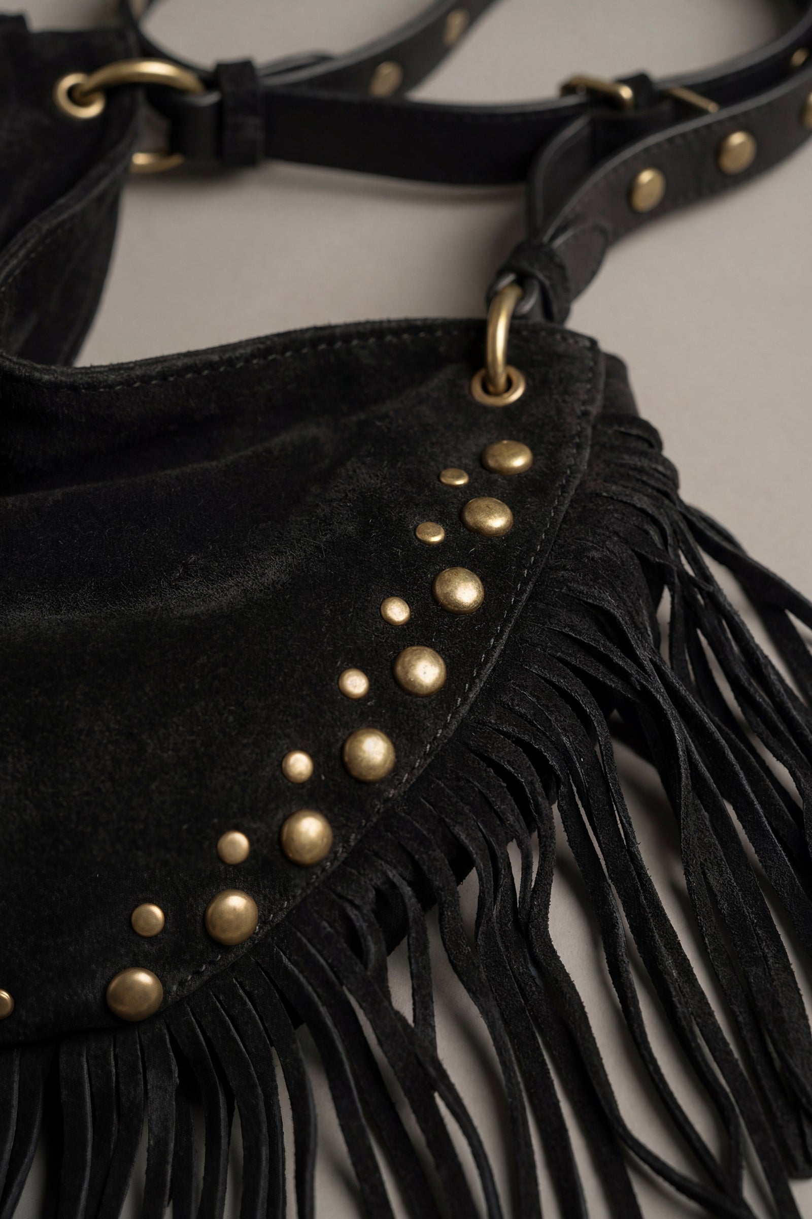 Studded detail and fringe on black faux suede slouchy bag