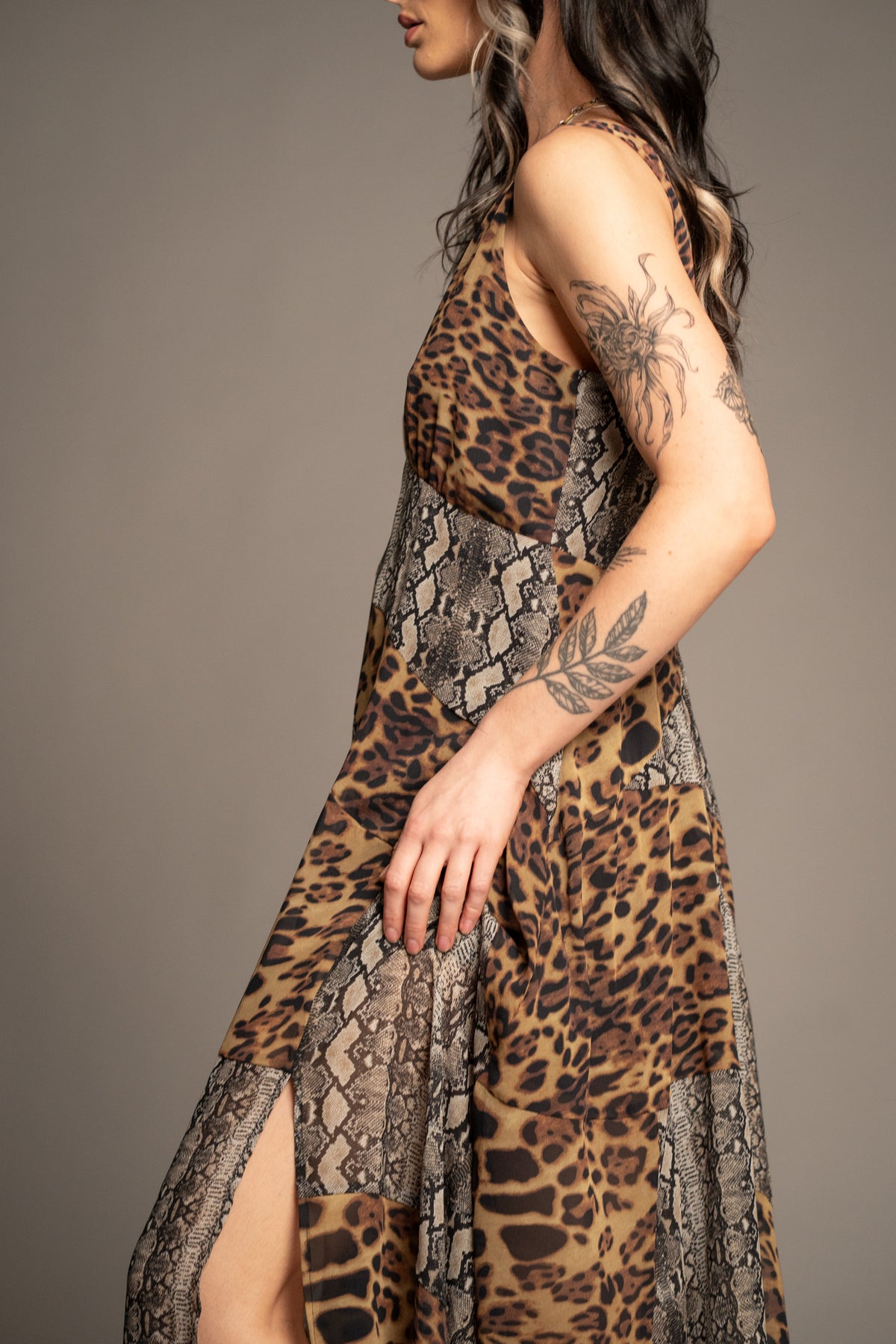 Little Lies Zadie Animal Handkerchief Dress side view showcasing mixed animal print design, flowing silhouette and handkerchief hem detail