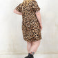 Model wearing Saint and Sinner Leopard T-Shirt Dress, a leopard print t-shirt dress with Concealed back zip closure