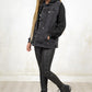 Model wearing Hellraiser Denim Jacket - black wash denim jacket with fully buttoned front, true pockets and adjustable drawstring hood