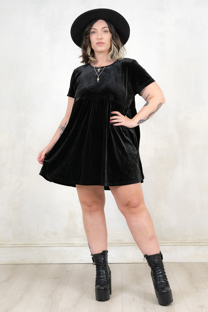 Model wearing Velvet Goldmine Black Smock Dress, a black, velvet, smock dress