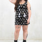 Model wearing Ziggy Stardust Sequin Mini Dress, a Black and silver star pattern sequin mini dress with concealed back zip closure and scoop neck