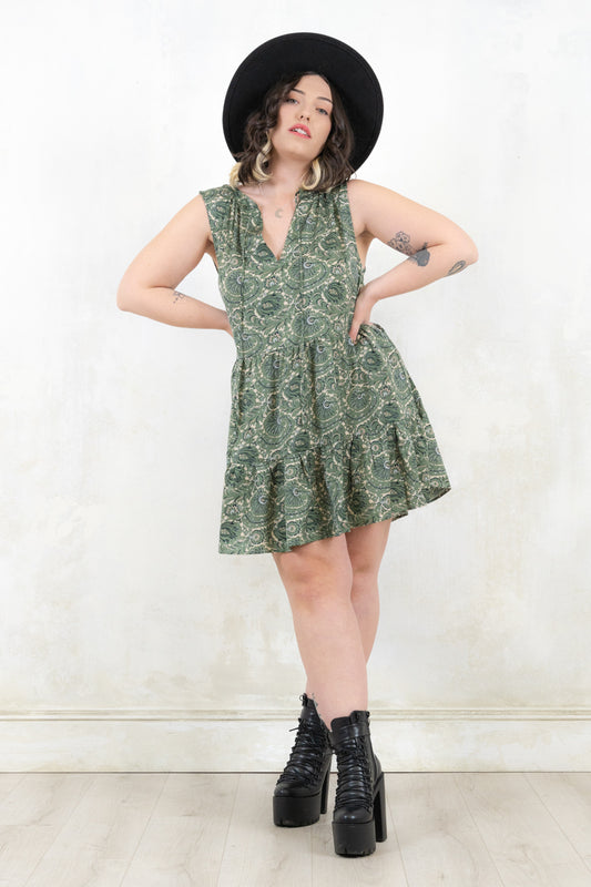 Model wearing Landslide Sage Smock -  sage, paisley print, sleeveless smock dress with a tiered a-line skirt and plunge neckline