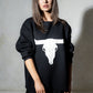 Model wearing Bison Monochrome Heavy Knit, a black relaxed fit jumper with hand drawn bison graphic