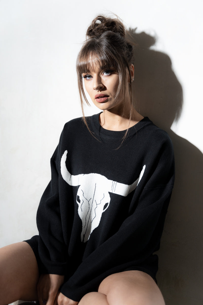 Model wearing Bison Monochrome Heavy Knit, a black relaxed fit jumper with hand drawn bison graphic