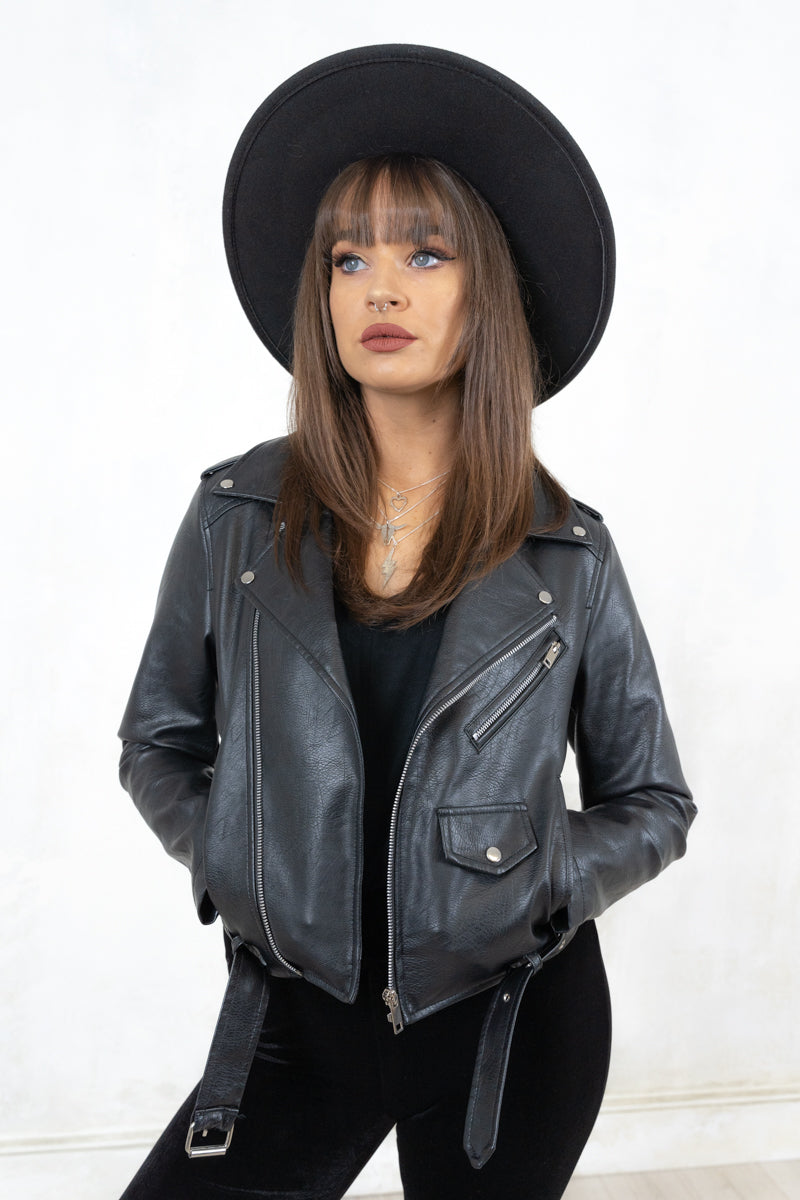 Model wearing Springsteen Biker Jacket - a black classic biker jacket with belted waistline, silver hardware and various pockets including a coin pocket plus popper shoulder epaulettes.