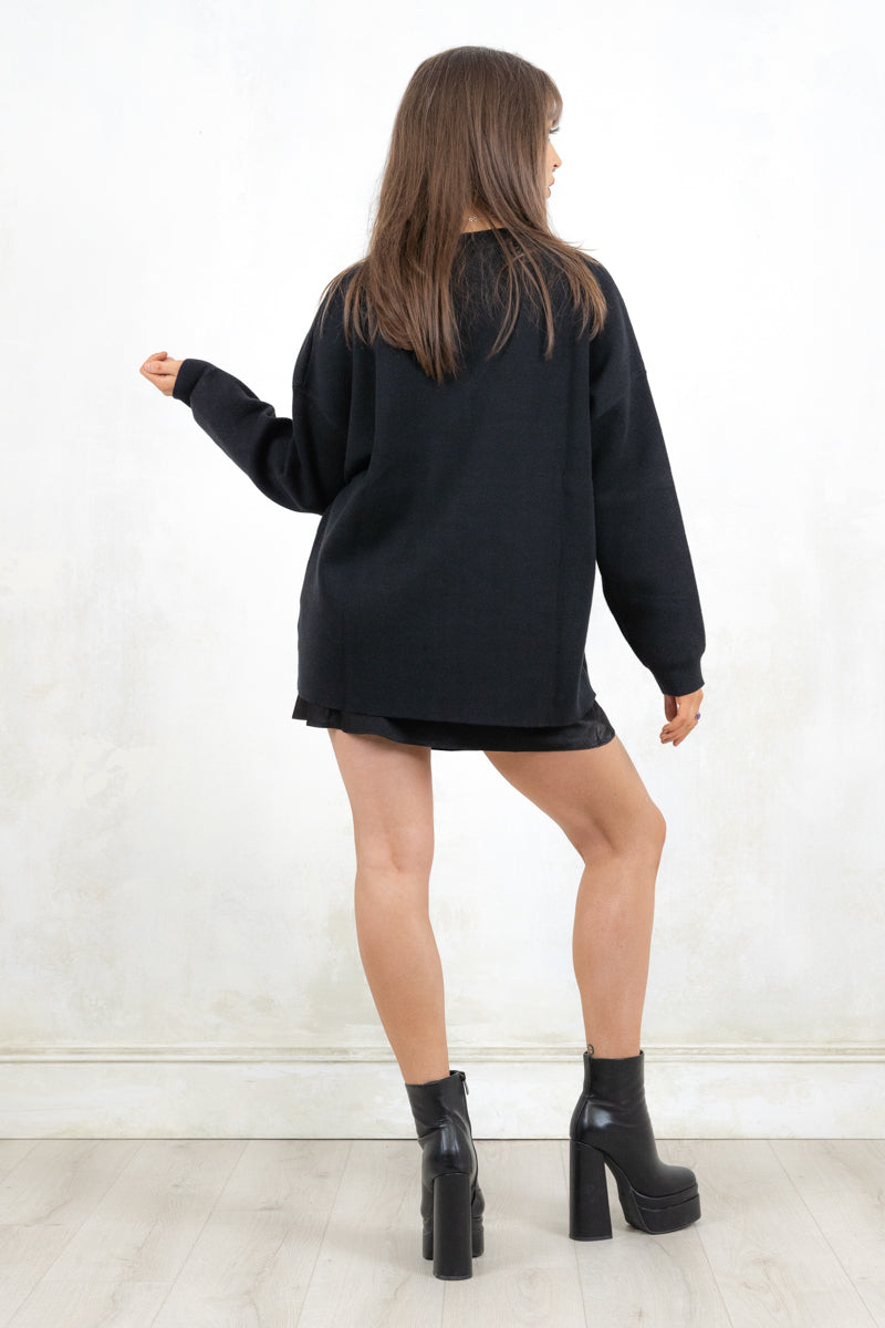 Model wearing Bison Monochrome Heavy Knit, a  black relaxed fit jumper with hand drawn bison graphic