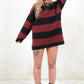Model wearing Kurt Striped Knit, relaxed fit black and oxblood strip knit jumper