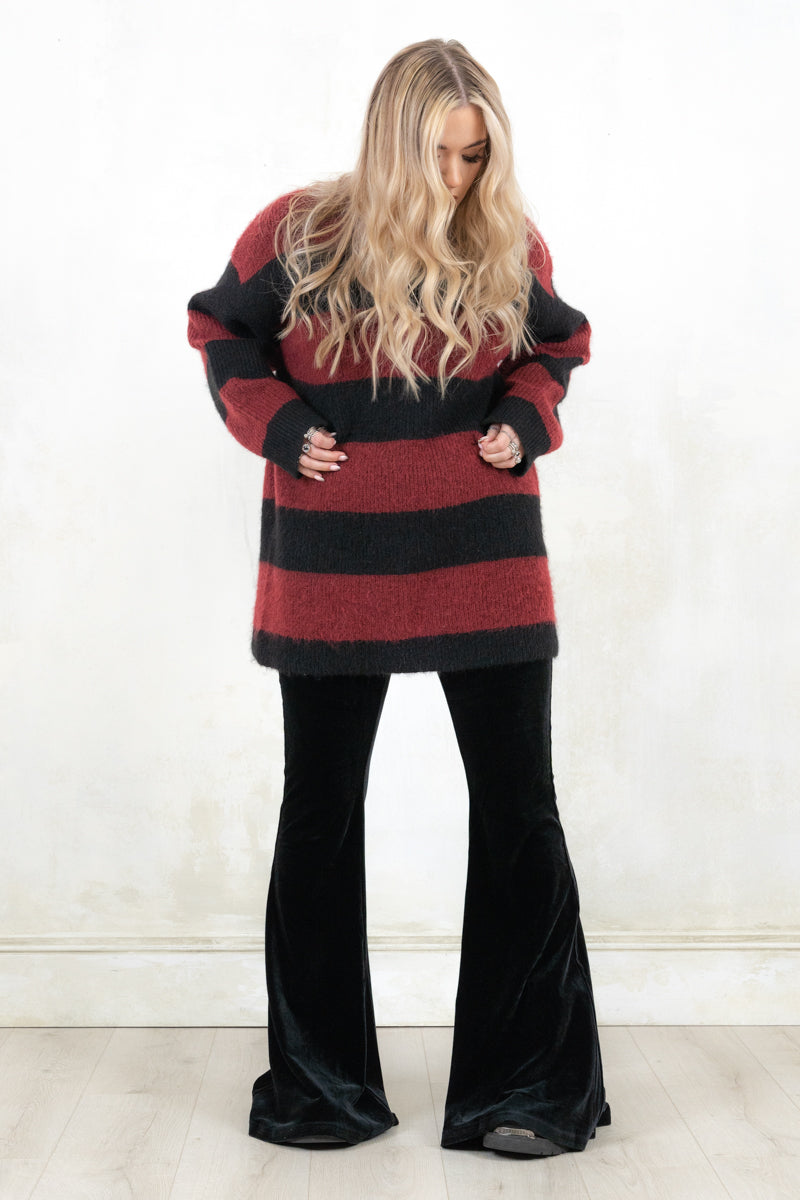 Model wearing Kurt Striped Knit. relaxed fit black and oxblood strip knit jumper
