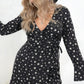 Model wearing Midnight Sky Wrap Dress , a star print dress with true wrap front, fluted cuffs and deep v neck