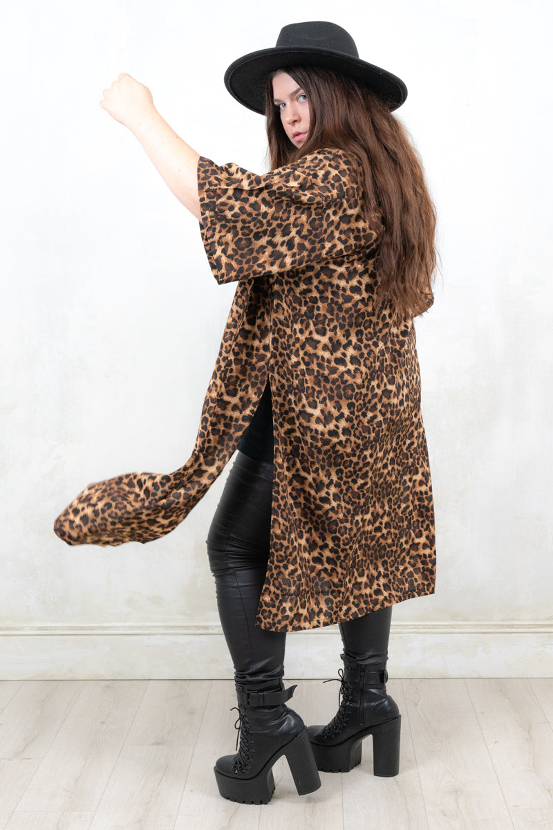 Model wearing Runaway Leopard Kimono, an open front leopard print kimono with side splits