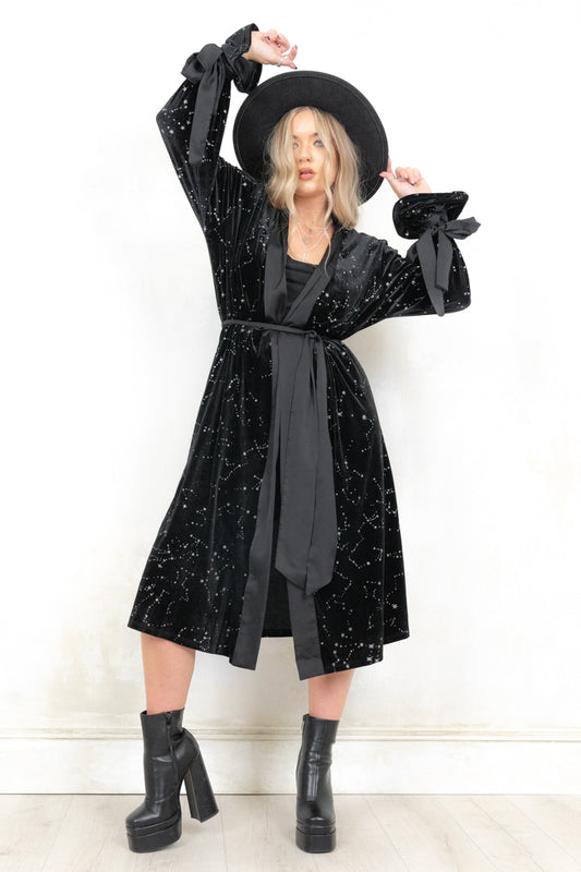 Model wearing Spellbound Constellation Velvet Kimono, a Black Velvet kimono with Silver Glitter Open front with tie waist, satin trim, gathered flared cuffs with satin tie and side splits
