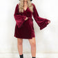 Model wearing Rock City Wine Velvet Wrap Dress, a wine velvet wrap dress