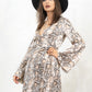 Model wearing Poison Heart Leopard Wrap Dress, a brown and white snake print wrap dress, True wrap style with flared sleeves and deep V-neck