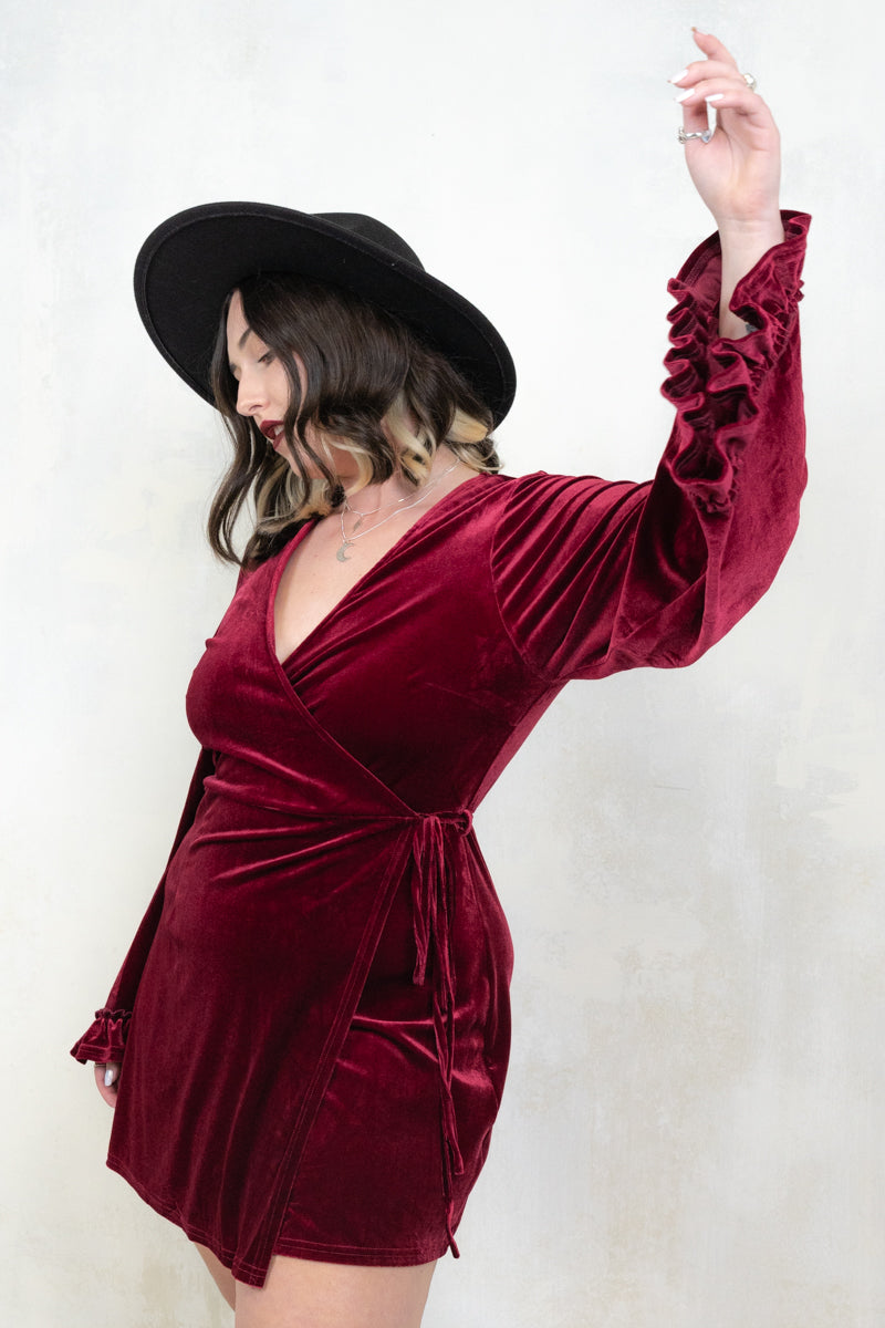 Model wearing Rock City Wine Velvet Wrap Dress, a wine velvet wrap dress