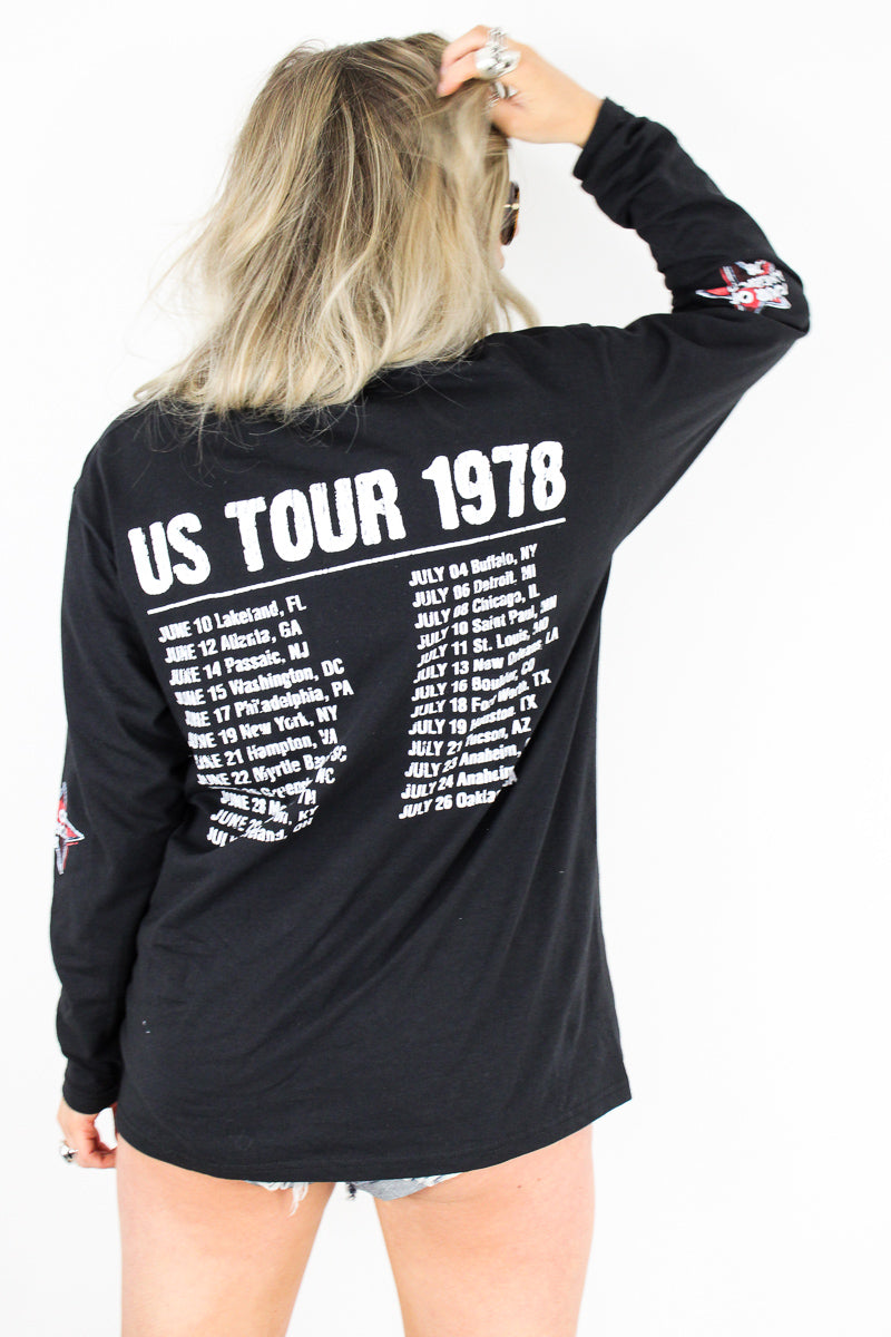 Model wearing The Rolling Stones '78 Long Sleeve Tee - Black Long Sleeve Rolling Stones Tee with American Flag Print Tongue Design on front and Tour Dates on back